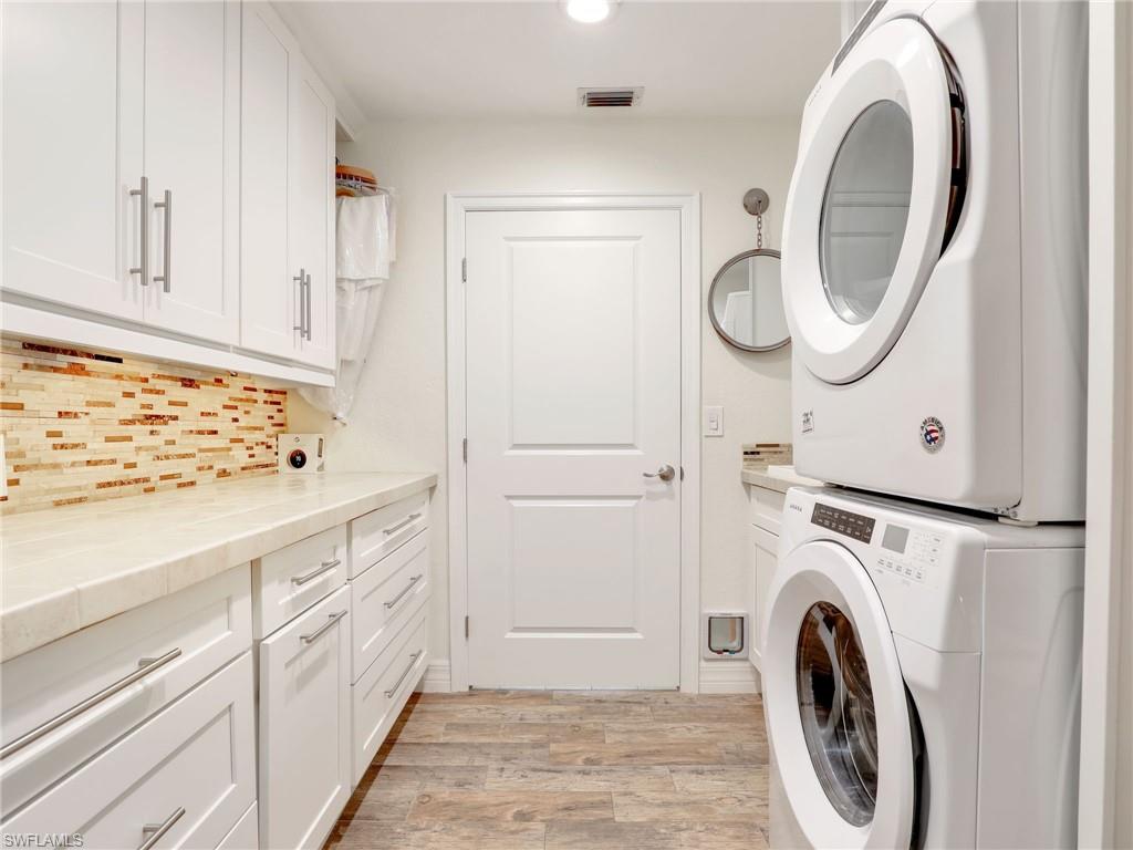 471 Ibis Way Naples, FL 34110 - Photo 35 of 40 a utility room with dryer and washer