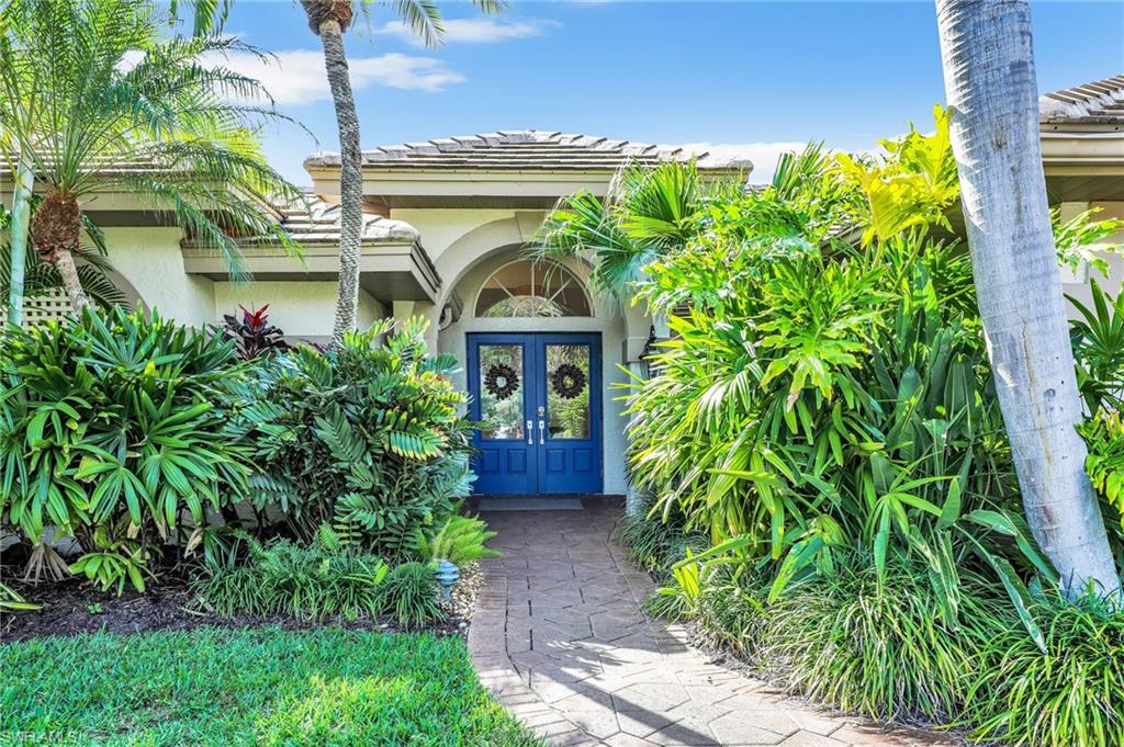 471 Ibis Way Naples, FL 34110 - Photo 36 of 40 a front view of a house with garden