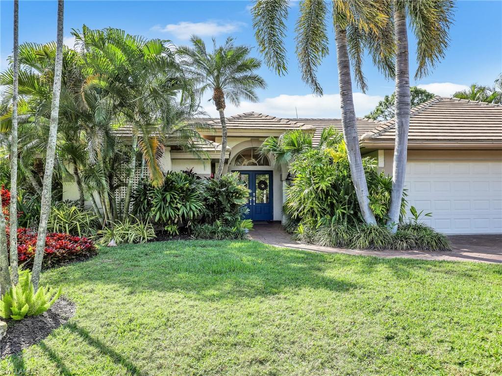 471 Ibis Way Naples, FL 34110 - Photo 37 of 40 a front view of a house with garden