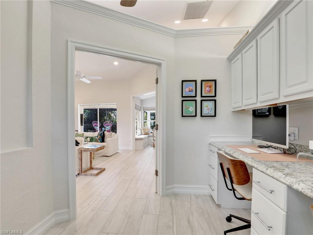 471 Ibis Way Naples, FL 34110 - Photo 4 of 40 a view of a kitchen with fridge and wooden floor