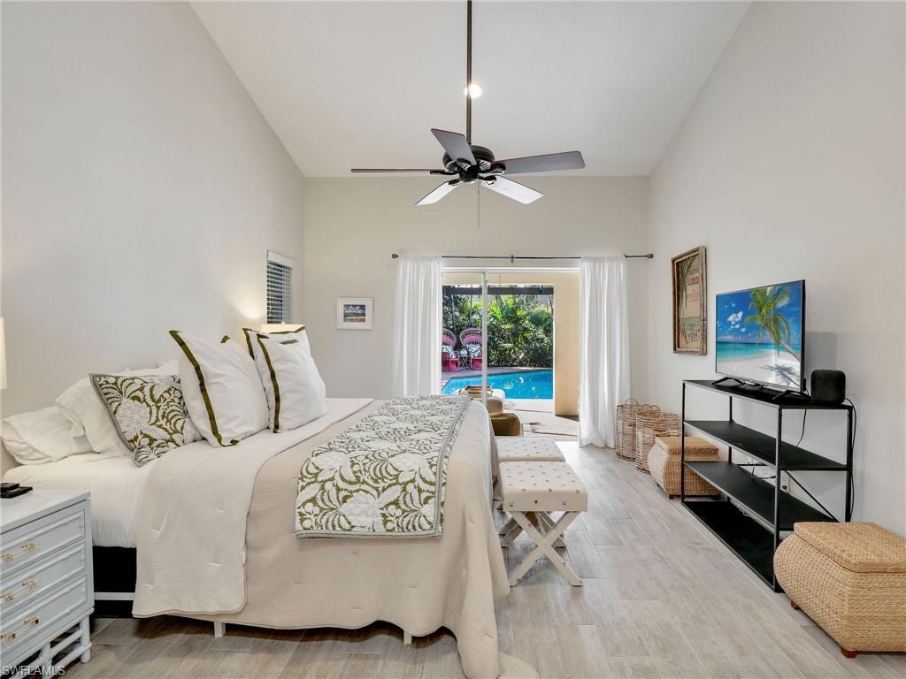 471 Ibis Way Naples, FL 34110 - Photo 8 of 40 a bedroom with a bed a couch and a window