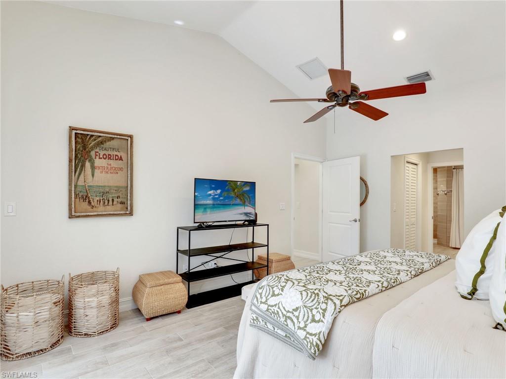 471 Ibis Way Naples, FL 34110 - Photo 9 of 40 a bedroom with furniture and a ceiling fan