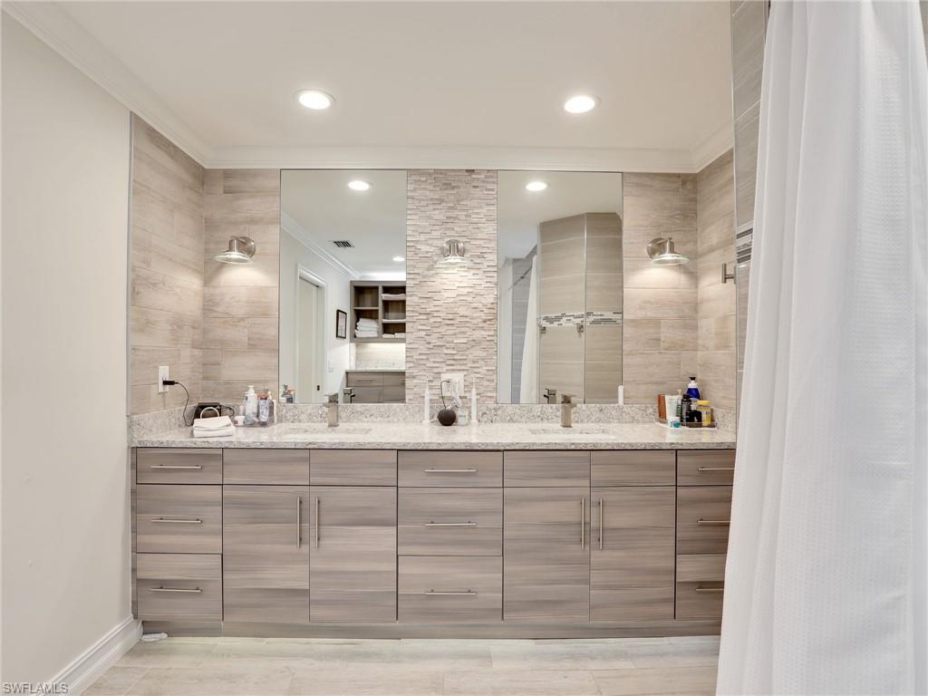 471 Ibis Way Naples, FL 34110 - Photo 10 of 40 a bathroom with a double vanity sink mirror and double