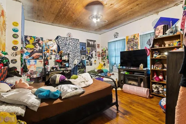 a bedroom with a bed and flat screen tv