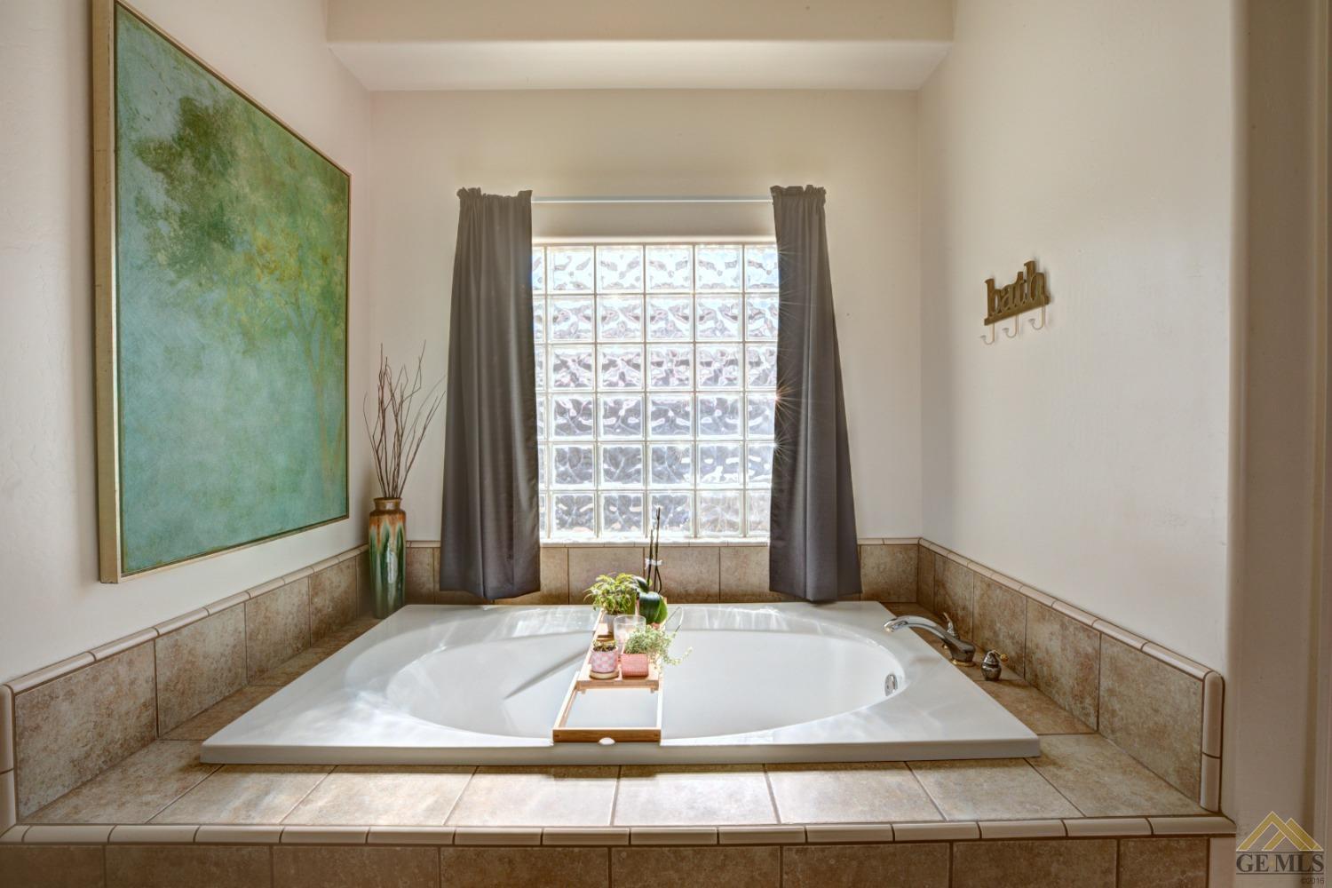 Undisclosed Address Shafter, CA 93263 - Photo 12 of 21 a bath tub sitting in a bathroom next to a window
