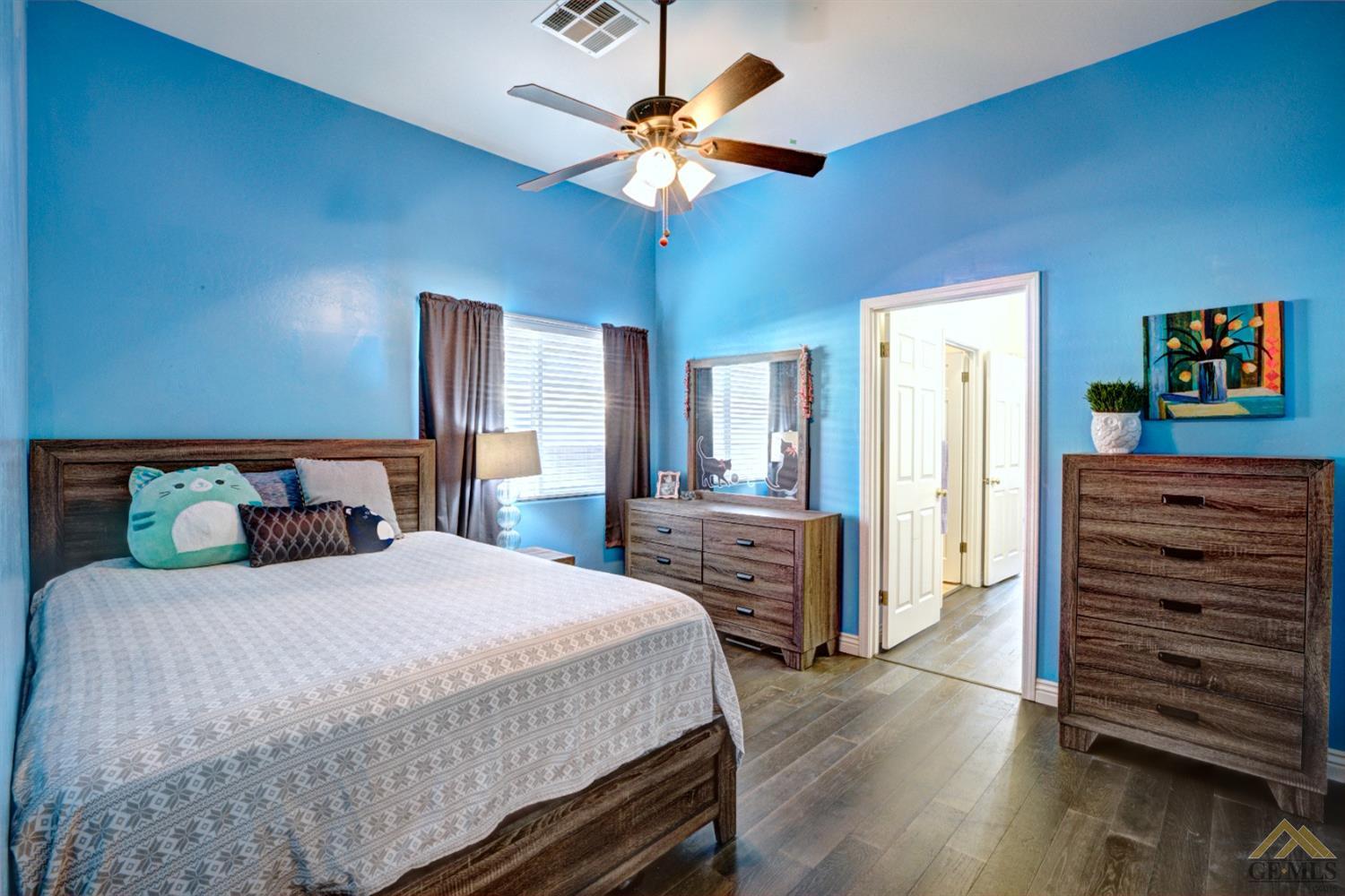 Undisclosed Address Shafter, CA 93263 - Photo 15 of 21 a bedroom with a bed a dresser and a chandelier