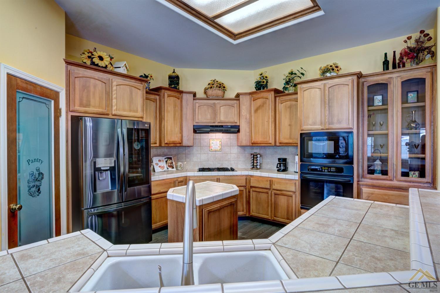 Undisclosed Address Shafter, CA 93263 - Photo 7 of 21 a kitchen with stainless steel appliances granite countertop a refrigerator and a stove