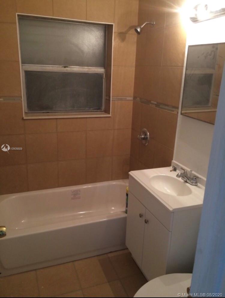 1131 West 4th Street Riviera Beach, FL 33404 - Photo 7 of 7 a bathroom with a sink toilet and tub