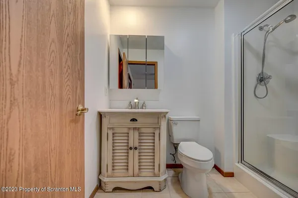 a bathroom with a toilet a sink and shower