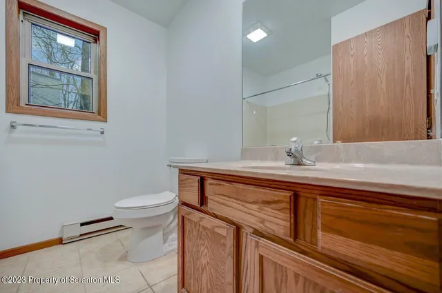 a bathroom with a sink a toilet and mirror