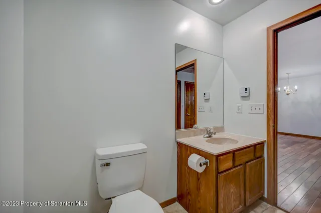 a bathroom with a sink a toilet and mirror