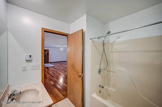 a bathroom with a glass shower door and a sink