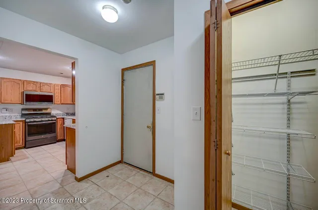 a view of kitchen with stainless steel appliances a refrigerator and a stove top oven
