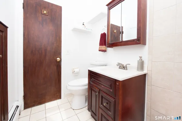 a bathroom with a sink toilet and mirror