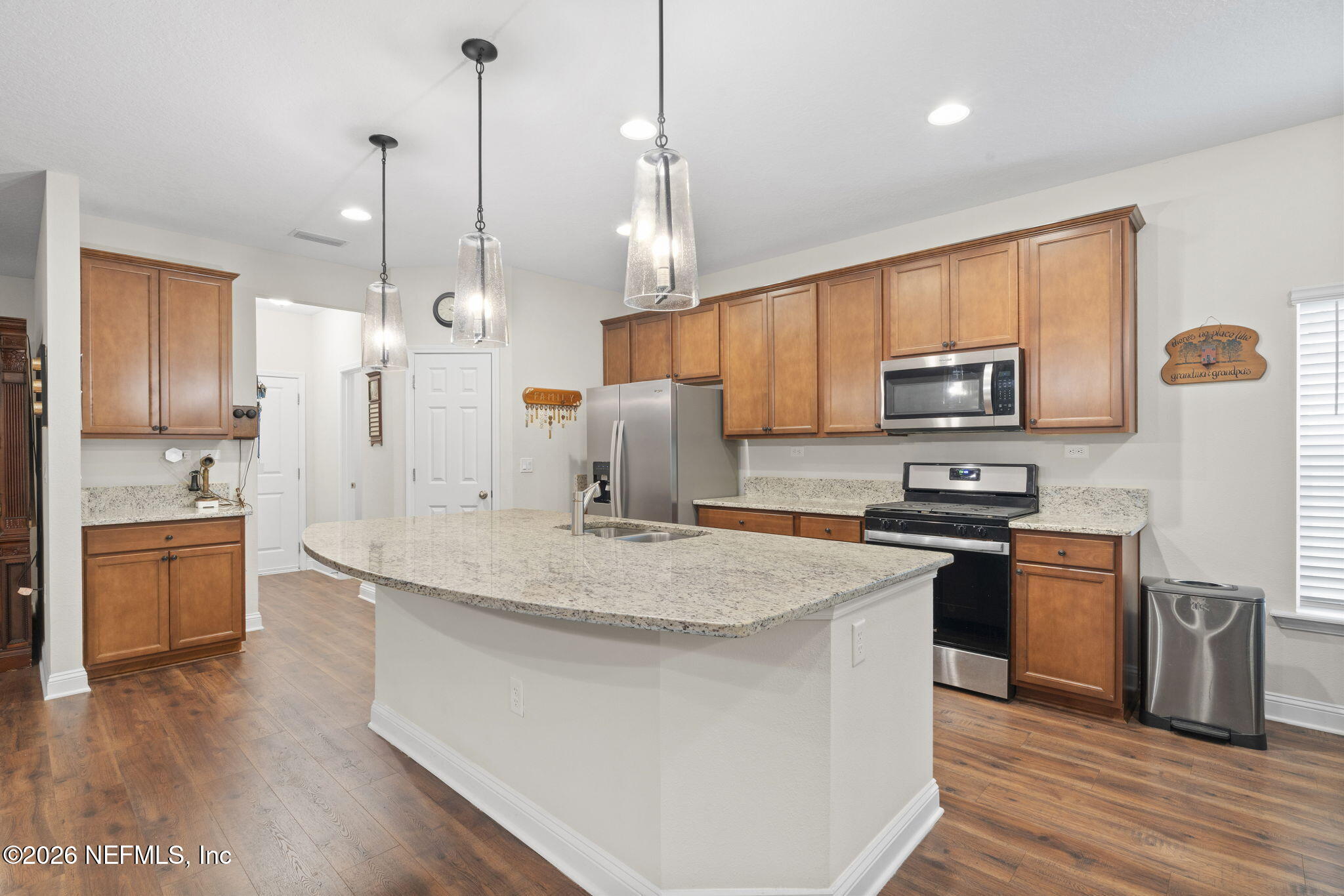620 Ivory Palm Road Orange Park, FL 32073 - Photo 11 of 53 a kitchen with stainless steel appliances granite countertop a sink a stove a refrigerator and island with wooden floor