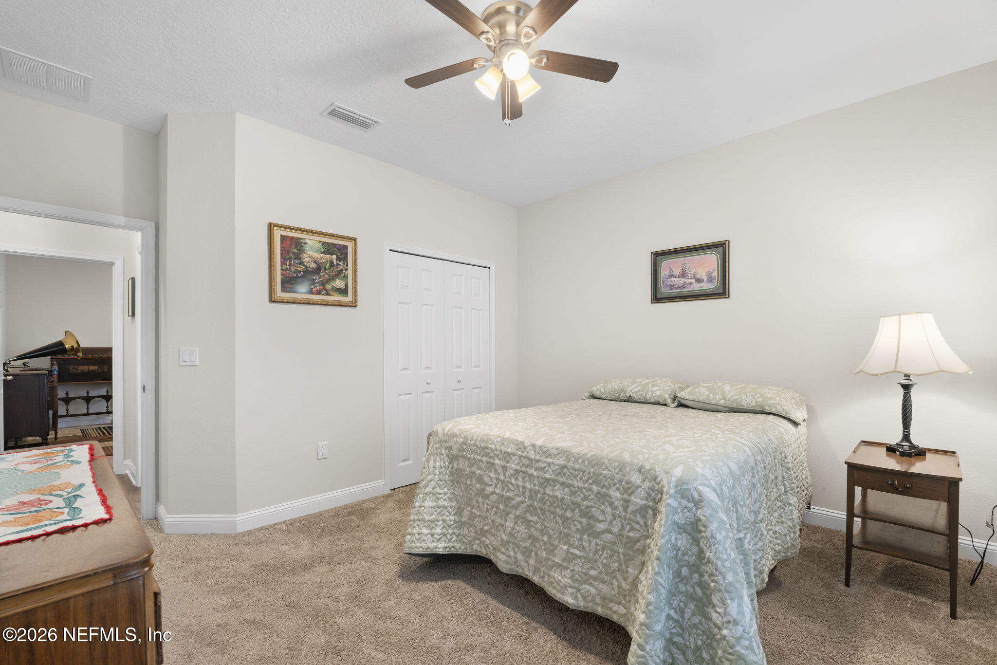 620 Ivory Palm Road Orange Park, FL 32073 - Photo 19 of 53 a bedroom with a bed and a chandelier