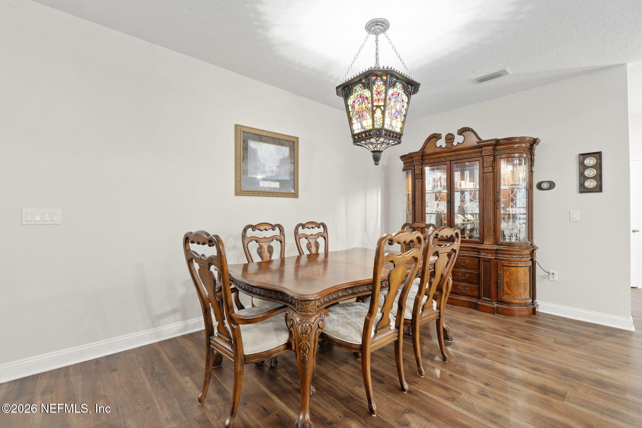 620 Ivory Palm Road Orange Park, FL 32073 - Photo 6 of 53 a view of a dining room with furniture wooden floor and a chandelier