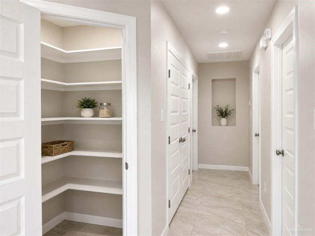 707 Palmer Road, Unit 3 Mission, TX 78573 - Photo 7 of 8 Spacious pantry with multiple built-in shelves and a neutral color palette