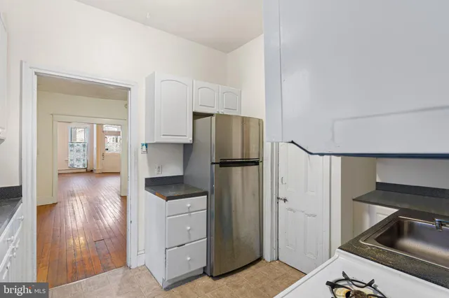 a kitchen with a refrigerator and a sink