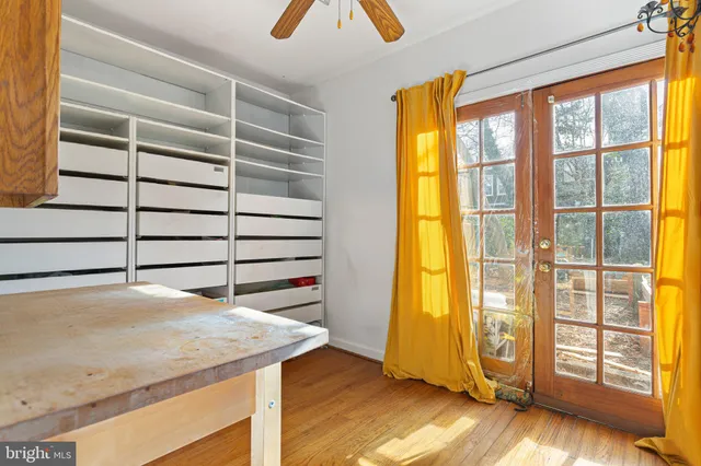 a kitchen with a wooden floor and a window