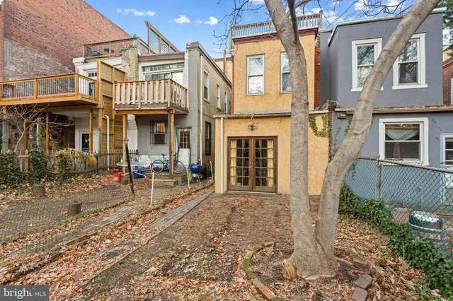 front view of a house with a chairs and table in a patio