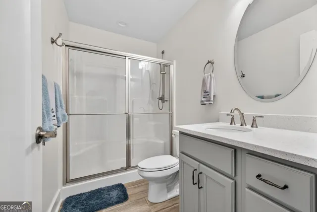 an aerial view of a swimming pool with a yard and lake view