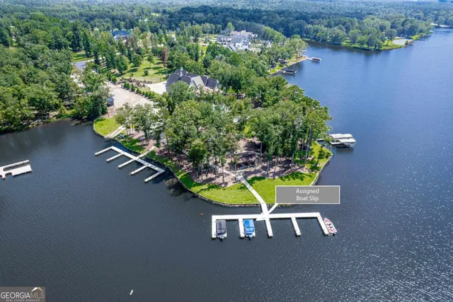 a view of a house with a big yard and large trees