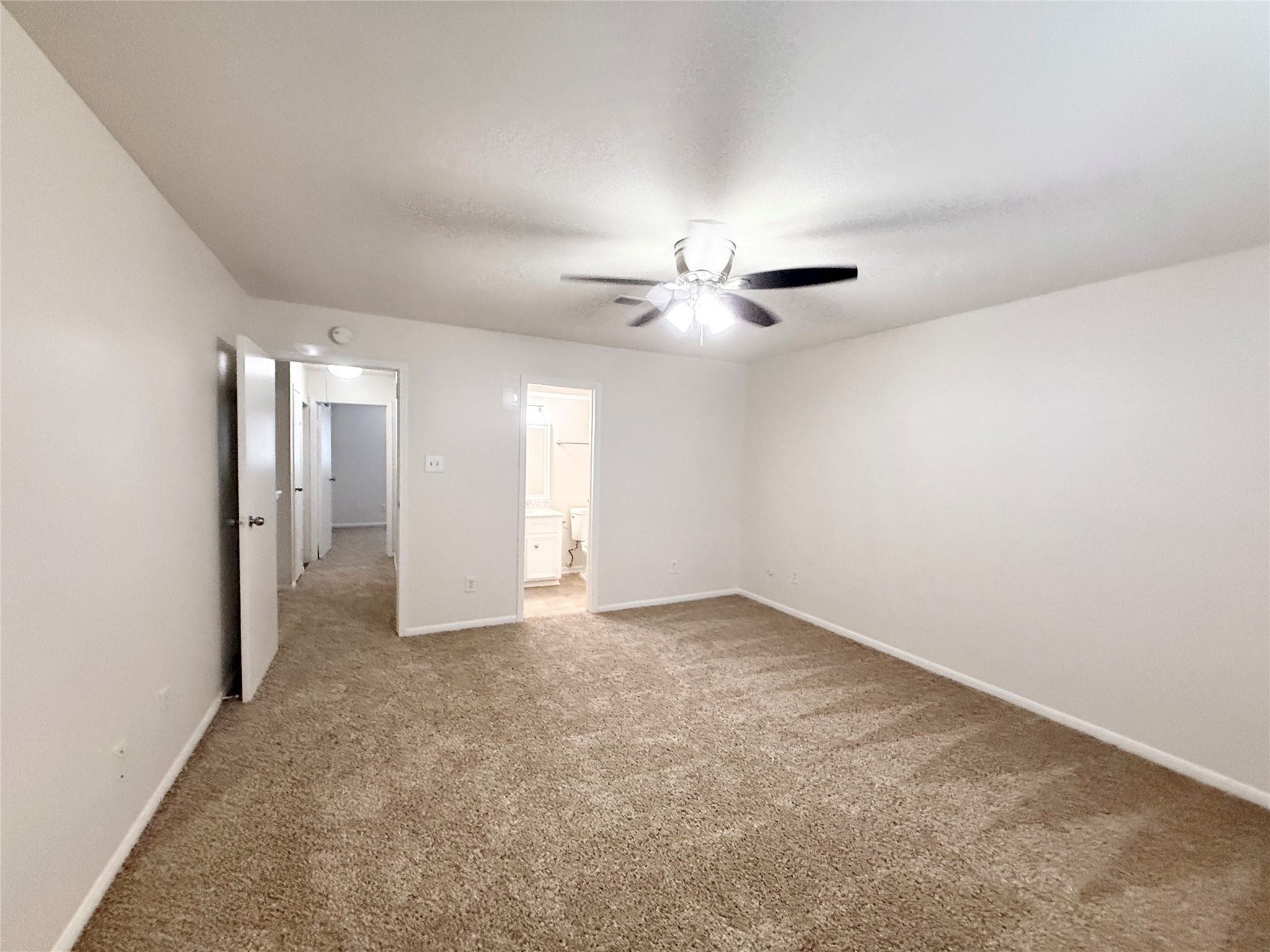 1497 Springrock Lane Houston, TX 77055 - Photo 15 of 23 a view of an empty room with a ceiling fan