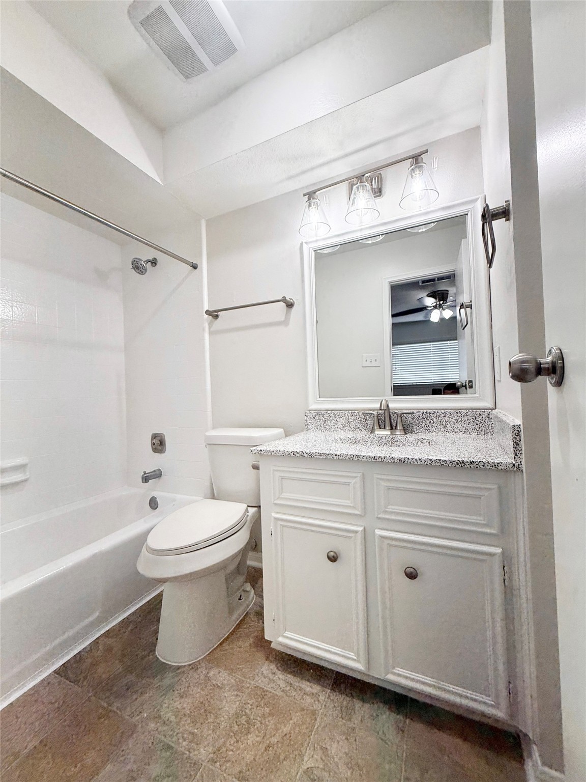 1497 Springrock Lane Houston, TX 77055 - Photo 21 of 23 a bathroom with a granite countertop sink a toilet mirror and bathtub