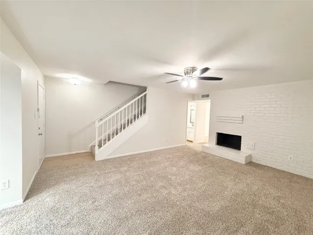 a view of an empty room with a fireplace