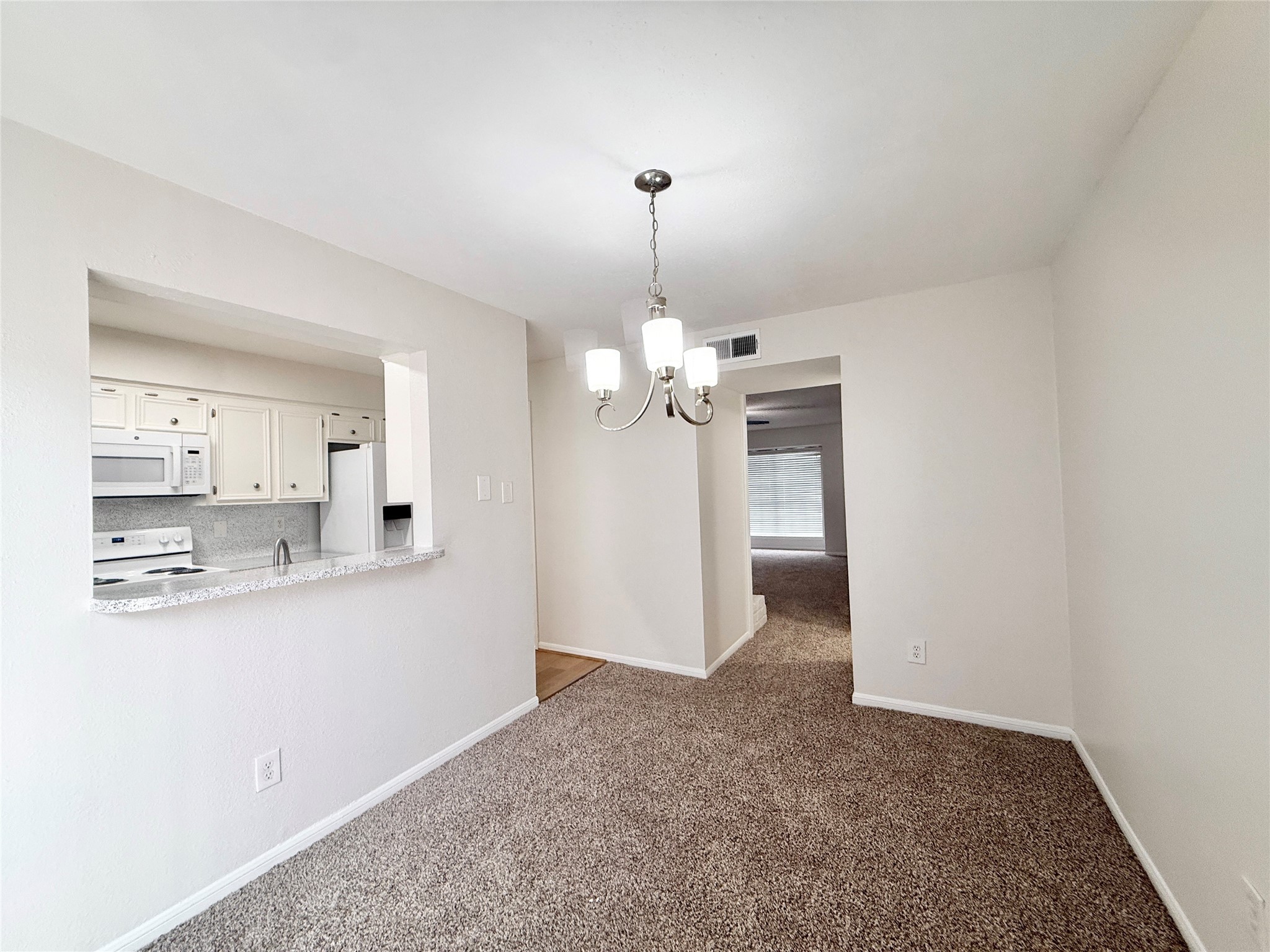 1497 Springrock Lane Houston, TX 77055 - Photo 7 of 23 a view of a kitchen with a sink and chandelier