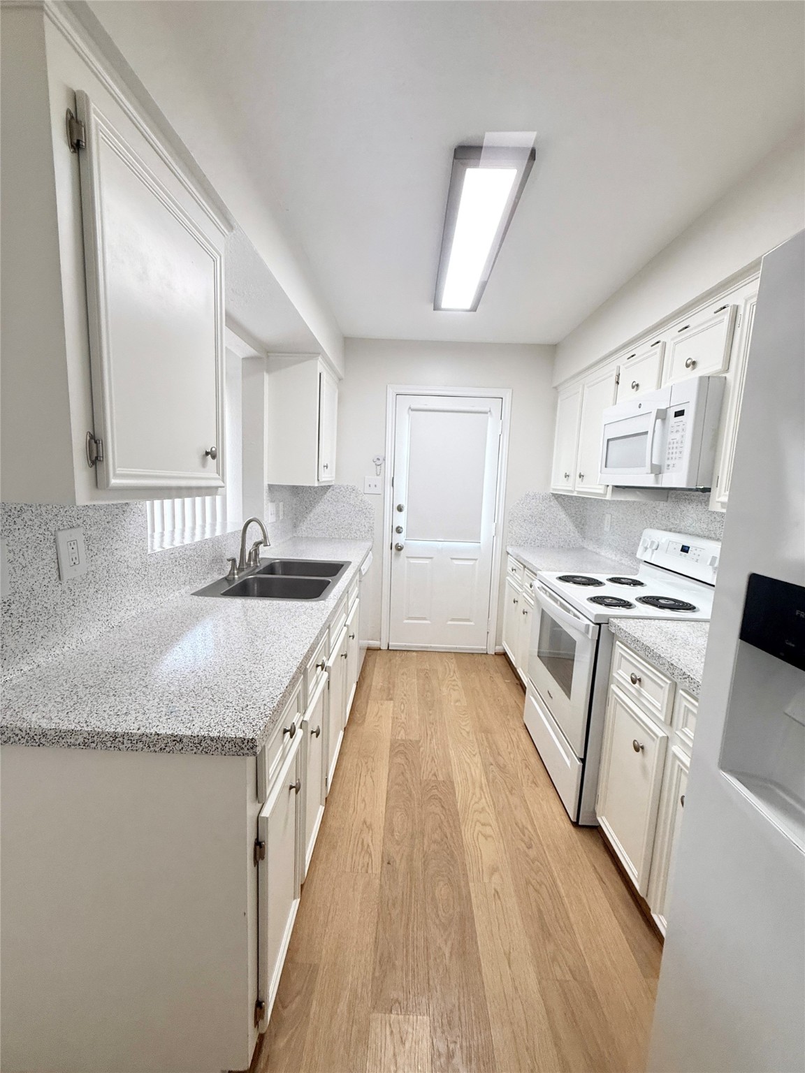 1497 Springrock Lane Houston, TX 77055 - Photo 9 of 23 a kitchen with granite countertop a sink appliances cabinets and counter space