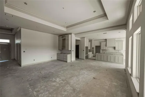 a view of a kitchen with large windows