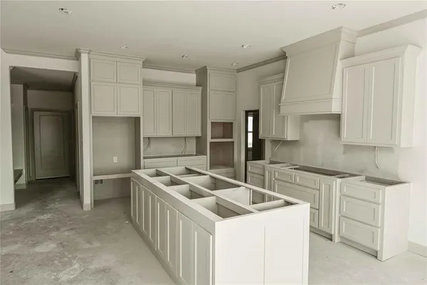 a kitchen that has a sink and a stove in it