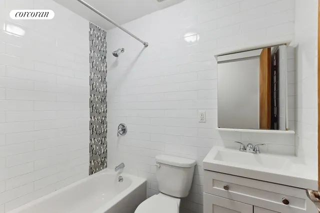 a spacious bedroom with a bed and couch