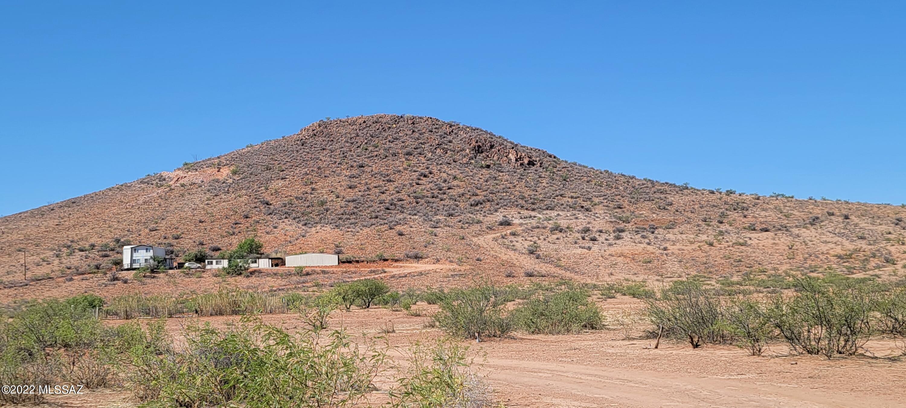 3399 Red Stag Road Pearce, AZ 85625 - Photo 4 of 47 a view of a dry yard with mountains in the background