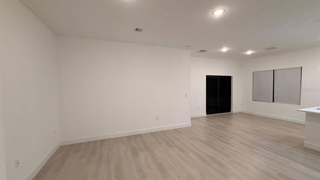 1597 Kerman Street North Port, FL 34288 - Photo 18 of 26 a view of an empty room with wooden floor