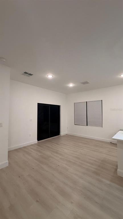 1597 Kerman Street North Port, FL 34288 - Photo 19 of 26 a view of an empty room with wooden floor and a window