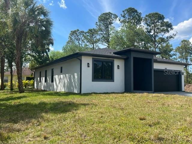 1597 Kerman Street North Port, FL 34288 - Photo 2 of 26 a house view with a garden space