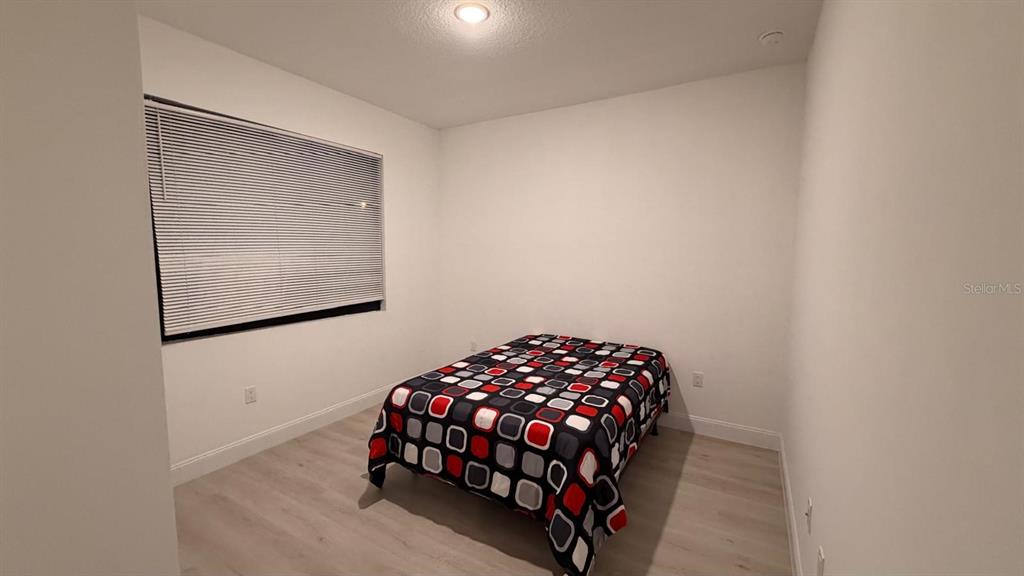 1597 Kerman Street North Port, FL 34288 - Photo 23 of 26 a bedroom with a bed and a window