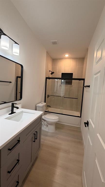 1597 Kerman Street North Port, FL 34288 - Photo 25 of 26 a bathroom with a sink a toilet a mirror and vanity