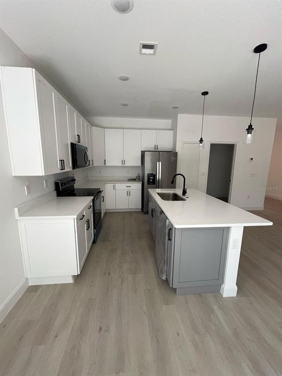 1597 Kerman Street North Port, FL 34288 - Photo 8 of 26 a kitchen with a stove a sink and a refrigerator