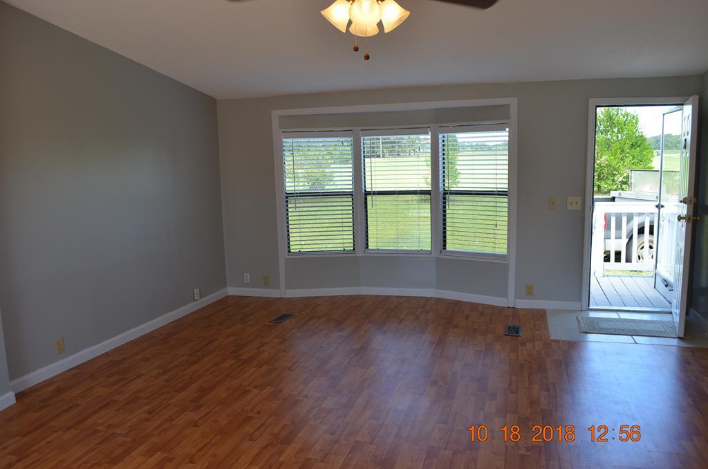 1055 Burnett Road Byron, GA 31008 - Photo 11 of 23 a view of an empty room with wooden floor and a window