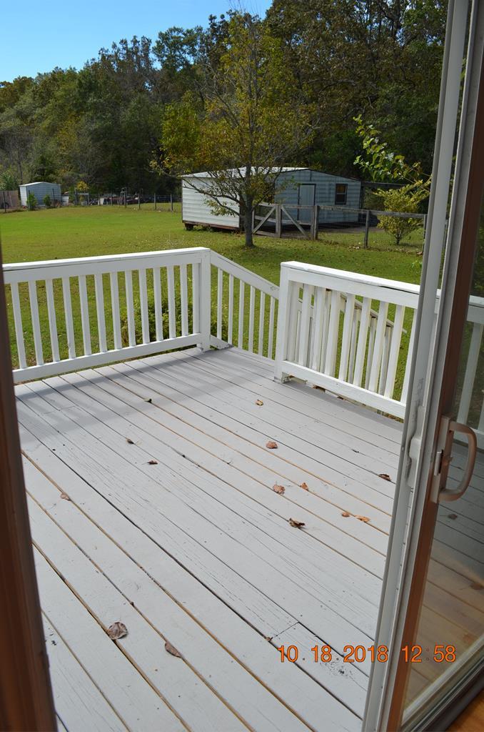 1055 Burnett Road Byron, GA 31008 - Photo 17 of 23 a view of a wooden deck with a yard