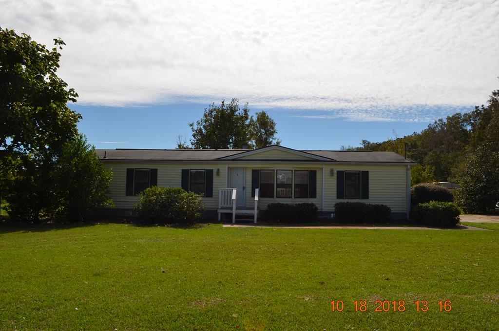 1055 Burnett Road Byron, GA 31008 - Photo 22 of 23 a view of a house with back yard and a garden