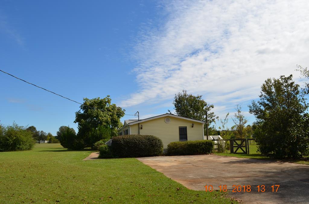 1055 Burnett Road Byron, GA 31008 - Photo 23 of 23 a front view of a house with a yard and trees