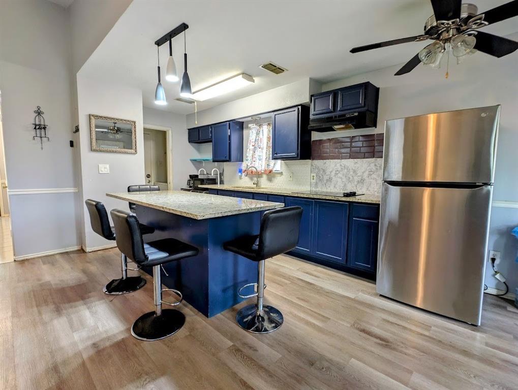 1901 Bosque Lane Arlington, TX 76006 - Photo 7 of 13 a kitchen with kitchen island a counter space a sink appliances and cabinets