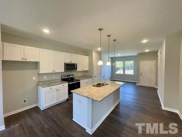 a kitchen with a sink stove and refrigerator