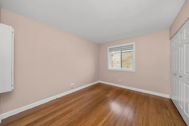 a view of a room with wooden floor and windows