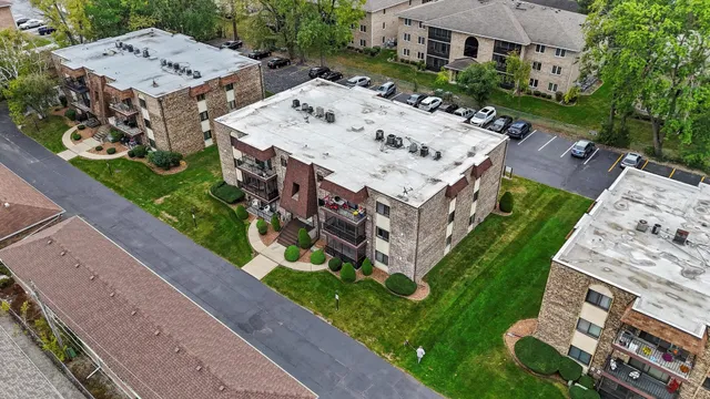a view of a house with a big yard and large trees